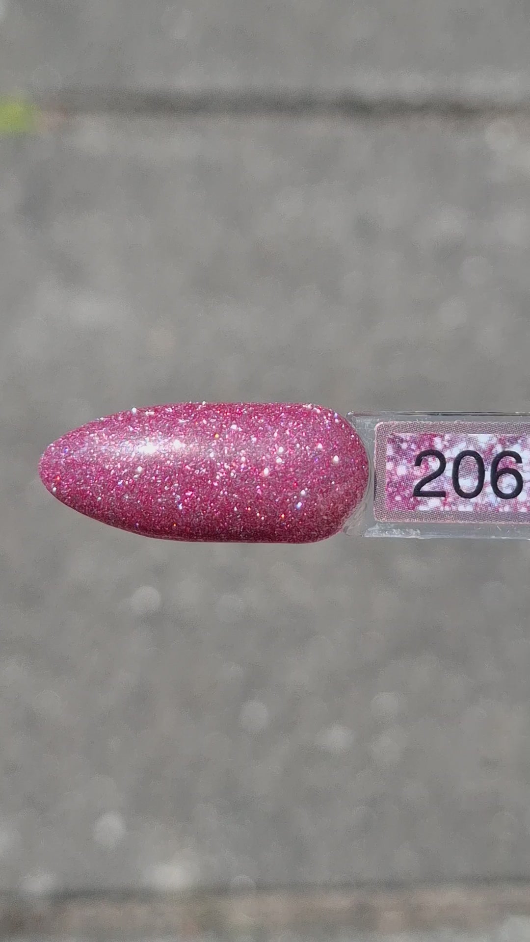 Quida Gelpolish 206 Crystal Crush - warm roze met mauve-paarse glitter gelpolish aangebracht op nagels in het zonlicht, 15ml